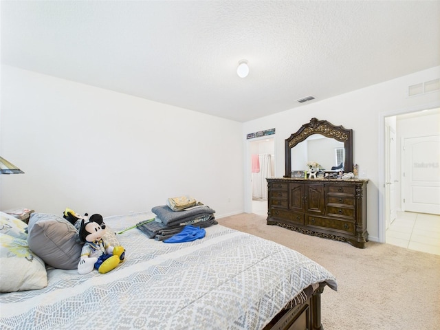 5751 Lakeside Landings Blvd, Winter Haven, FL 33881 - bedroom featuring light colored carpet and a textured ceiling