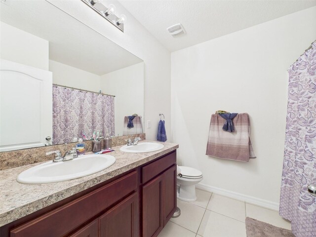5751 Lakeside Landings Blvd, Winter Haven, FL 33881 - bathroom with double vanity, tile patterned floors, and a shower with shower curtain