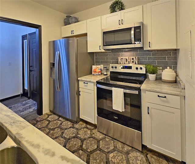 816 Pinewood Ct Unit 3126, Haines City, FL 33844 - kitchen with stainless steel appliances, white cabinets, and backsplash