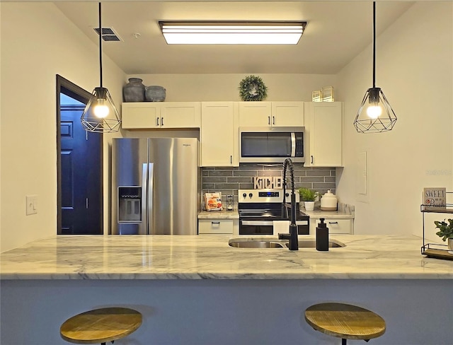 816 Pinewood Ct Unit 3126, Haines City, FL 33844 - kitchen with stainless steel appliances, light stone counters, and white cabinets