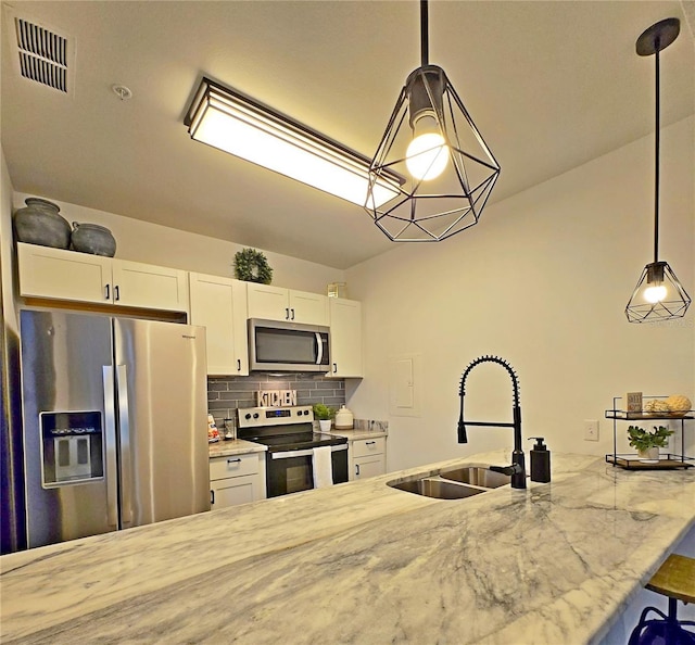 816 Pinewood Ct Unit 3126, Haines City, FL 33844 - kitchen featuring stainless steel appliances, white cabinetry, light stone counters, and tasteful backsplash