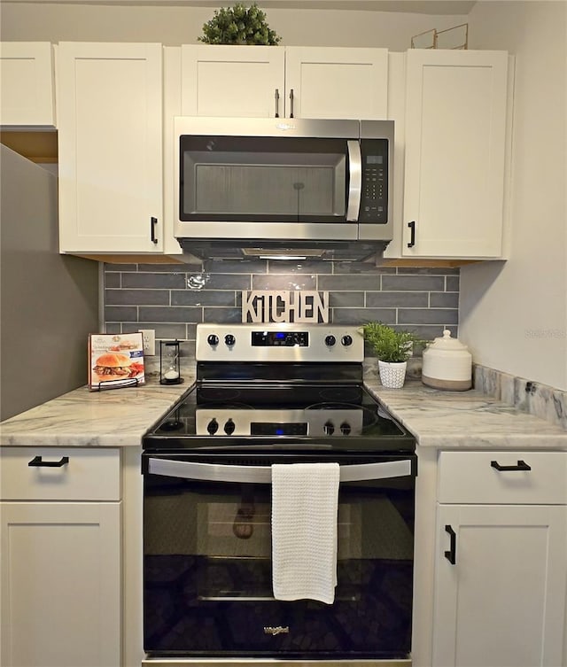 816 Pinewood Ct Unit 3126, Haines City, FL 33844 - kitchen featuring stainless steel appliances, white cabinetry, tasteful backsplash, and light stone countertops