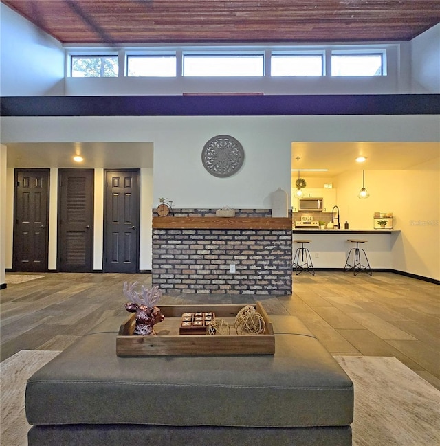 816 Pinewood Ct Unit 3126, Haines City, FL 33844 - living area with hardwood / wood-style floors, a towering ceiling, plenty of natural light, and wooden ceiling