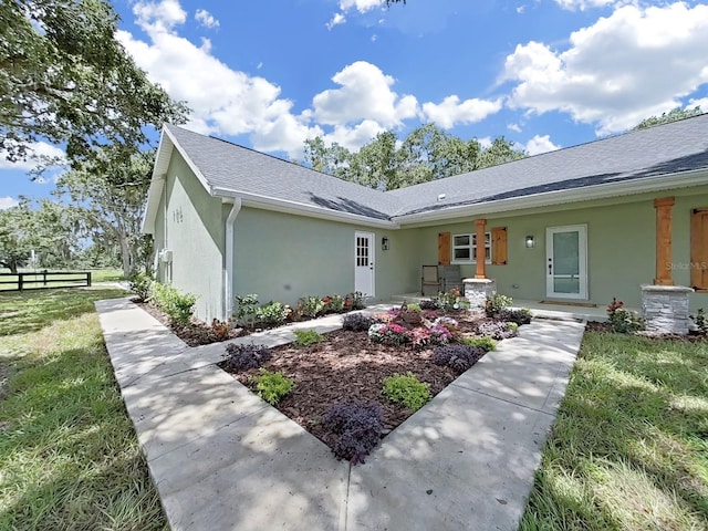 106 Corbett Rd, Lithia, FL 33547 - view of front facade featuring stucco siding and roof with shingles
