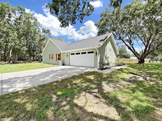 106 Corbett Rd, Lithia, FL 33547 - view of side of property featuring a garage, driveway, stucco siding, and a shingled roof