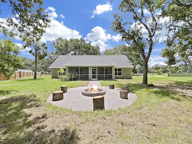 106 Corbett Rd, Lithia, FL 33547 - back of property with a sunroom, a fire pit, and a patio area
