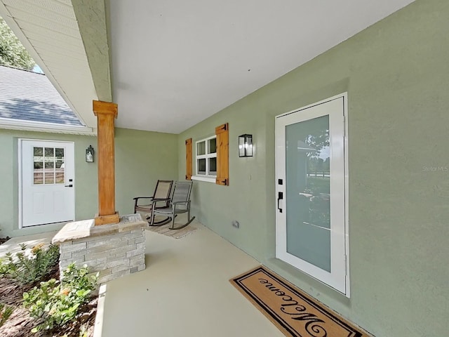 106 Corbett Rd, Lithia, FL 33547 - doorway to property featuring covered porch and stucco siding