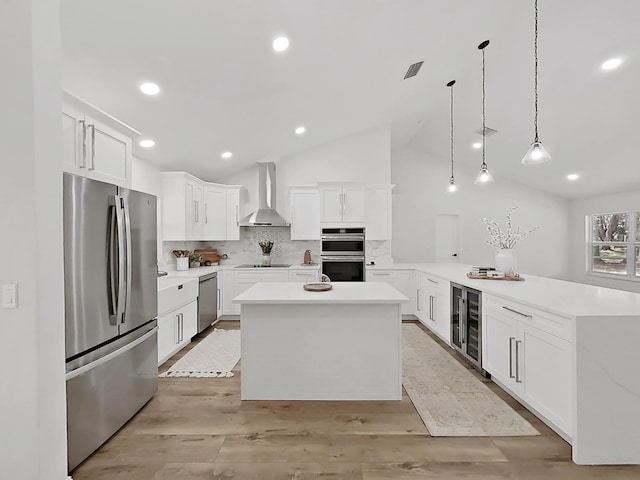 106 Corbett Rd, Lithia, FL 33547 - kitchen featuring stainless steel appliances, wall chimney exhaust hood, beverage cooler, a peninsula, and tasteful backsplash