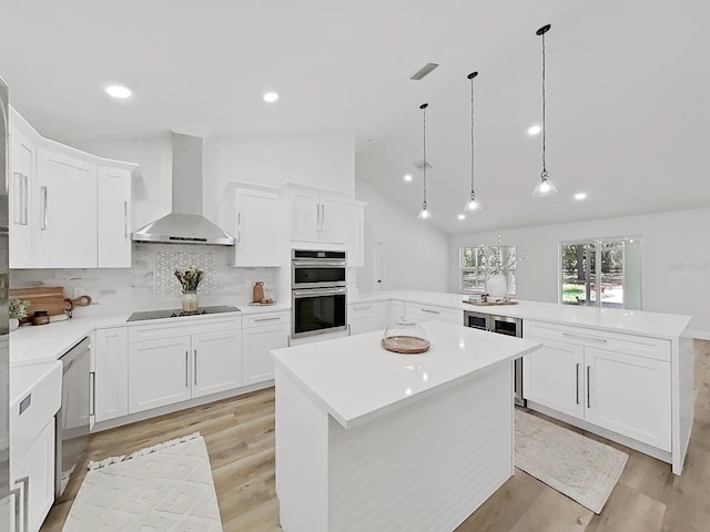 106 Corbett Rd, Lithia, FL 33547 - kitchen featuring double oven, wall chimney range hood, a peninsula, light countertops, and light wood-type flooring