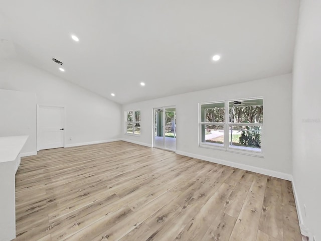 106 Corbett Rd, Lithia, FL 33547 - unfurnished living room with light wood-type flooring, lofted ceiling, and recessed lighting