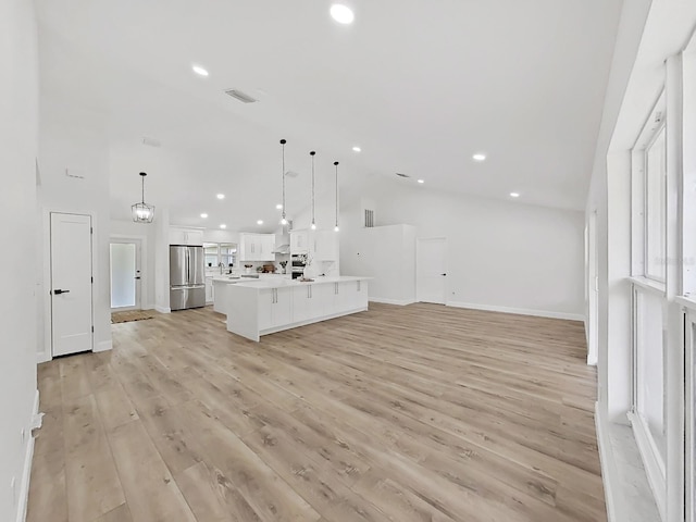 106 Corbett Rd, Lithia, FL 33547 - unfurnished living room featuring light wood-style floors, recessed lighting, and vaulted ceiling