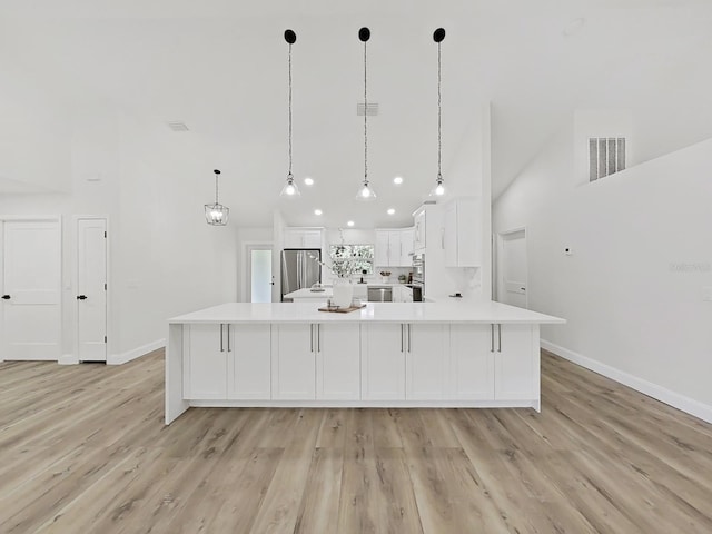 106 Corbett Rd, Lithia, FL 33547 - kitchen featuring appliances with stainless steel finishes, light countertops, white cabinets, light wood finished floors, and vaulted ceiling