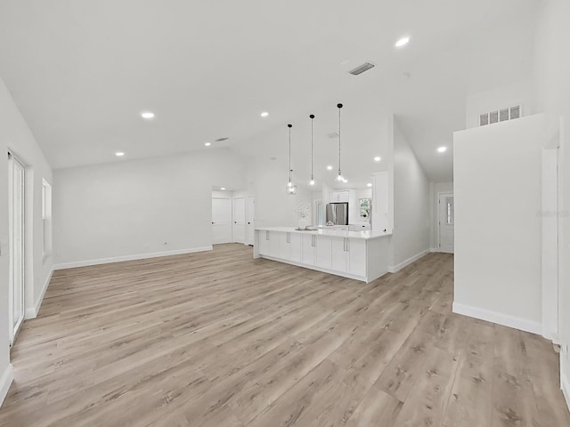 106 Corbett Rd, Lithia, FL 33547 - unfurnished living room featuring lofted ceiling, light wood-style flooring, and recessed lighting
