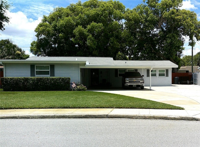 2021 Oliver Pl, Winter Haven, FL 33881 - single story home featuring concrete driveway, a front yard, a carport, and a metal roof