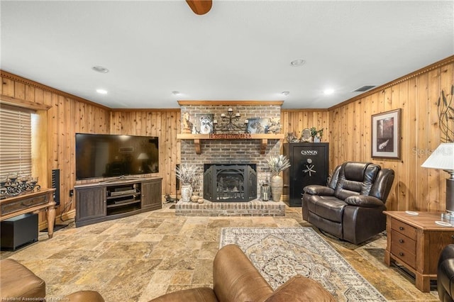 479 State Road 64 E, Zolfo Springs, FL 33890 - living room featuring wood walls, stone finish floors, ornamental molding, recessed lighting, and a fireplace