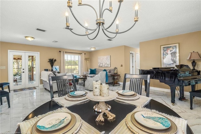 479 State Road 64 E, Zolfo Springs, FL 33890 - dining room with a chandelier, light marble finish floors, a textured ceiling, and french doors