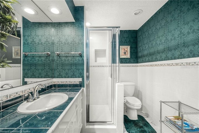 479 State Road 64 E, Zolfo Springs, FL 33890 - bathroom featuring tile walls, vanity, a stall shower, a textured ceiling, and wallpapered walls