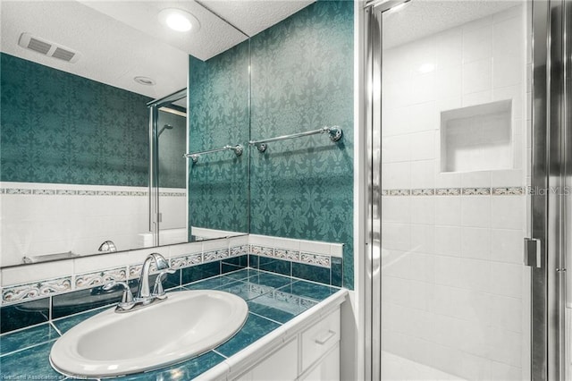 479 State Road 64 E, Zolfo Springs, FL 33890 - bathroom featuring a stall shower, vanity, and a textured ceiling
