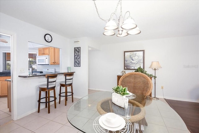 23465 Harborview Rd Unit 223, Punta Gorda, FL 33980 - dining room with a chandelier and light tile patterned floors