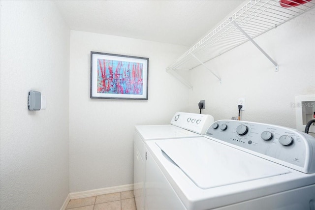23465 Harborview Rd Unit 223, Punta Gorda, FL 33980 - laundry area with washer and clothes dryer and light tile patterned floors