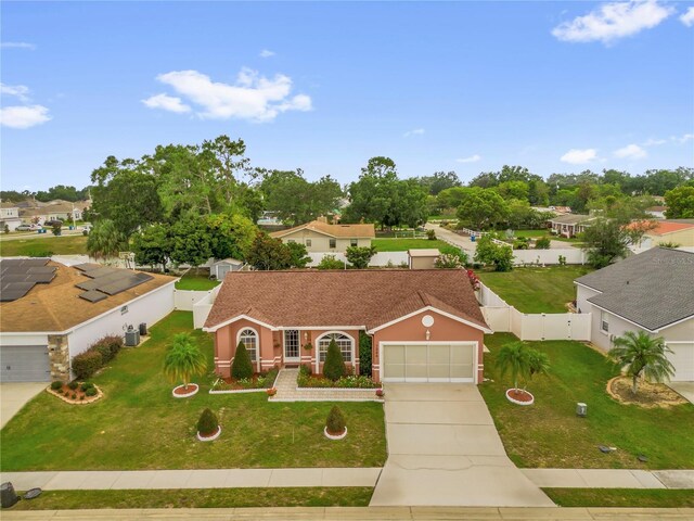 1366 Merrimack Pl, Davenport, FL 33837 - mediterranean / spanish-style home featuring concrete driveway, a fenced backyard, a gate, and a residential view