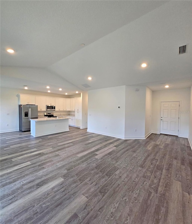 3040 W Joliet Rd, Avon Park, FL 33825 - unfurnished living room with dark wood-style flooring, recessed lighting, and lofted ceiling
