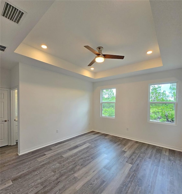 3040 W Joliet Rd, Avon Park, FL 33825 - empty room featuring a tray ceiling, dark wood finished floors, a ceiling fan, and recessed lighting