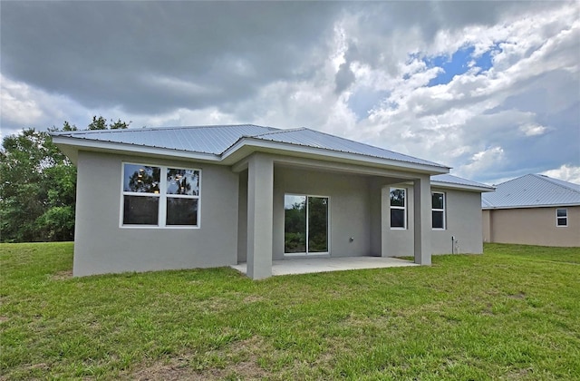 3040 W Joliet Rd, Avon Park, FL 33825 - rear view of house featuring stucco siding, a patio area, a metal roof, and a yard