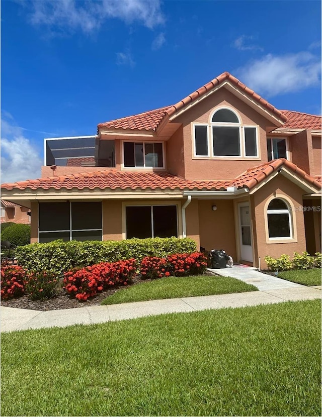 7906 Waterview Way Unit 7906, Winter Haven, FL 33884 - view of front of house with a tile roof, stucco siding, and a front yard