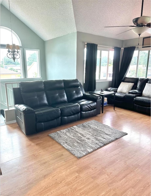 7906 Waterview Way Unit 7906, Winter Haven, FL 33884 - living room featuring lofted ceiling, a chandelier, a textured ceiling, wood finished floors, and ceiling fan