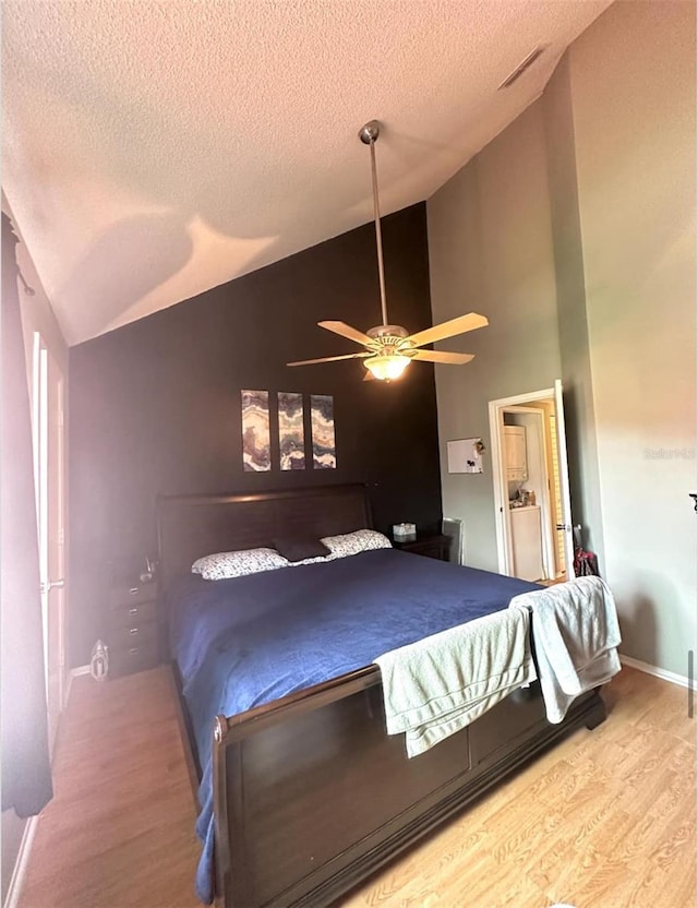 7906 Waterview Way Unit 7906, Winter Haven, FL 33884 - bedroom with a textured ceiling, wood finished floors, a ceiling fan, and high vaulted ceiling