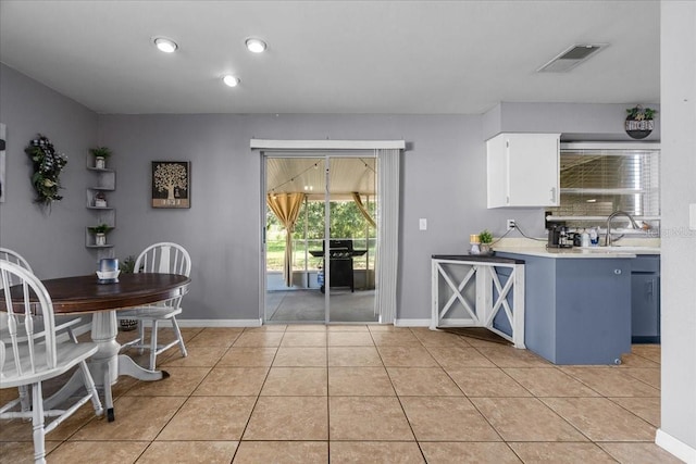 1100 Lowry Ave Unit 63, Lakeland, FL 33801 - kitchen featuring light countertops, white cabinets, and light tile patterned floors