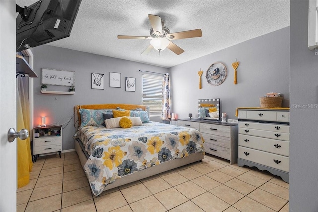 1100 Lowry Ave Unit 63, Lakeland, FL 33801 - bedroom with a textured ceiling, light tile patterned floors, and a ceiling fan