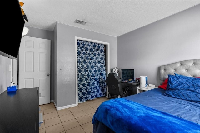 1100 Lowry Ave Unit 63, Lakeland, FL 33801 - bedroom with light tile patterned floors and a textured ceiling