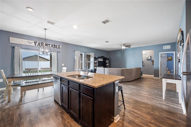 4662 Osprey Way, Winter Haven, FL 33881 - kitchen featuring stainless steel dishwasher, a ceiling fan, dark brown cabinets, dark wood-style floors, and a kitchen breakfast bar