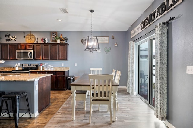 4662 Osprey Way, Winter Haven, FL 33881 - dining space featuring light wood-type flooring and a chandelier