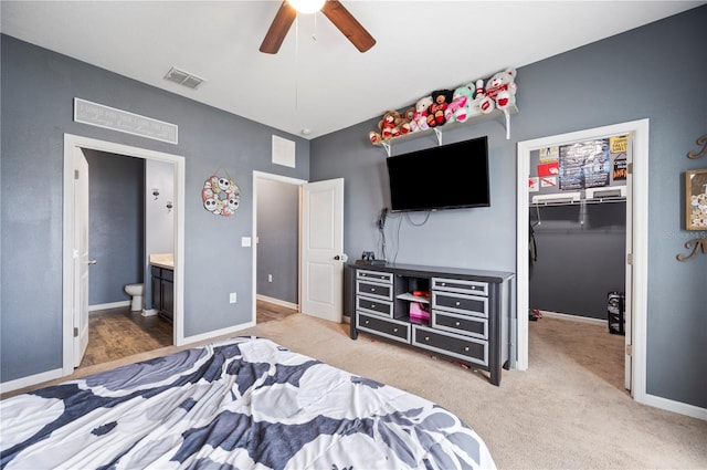 4662 Osprey Way, Winter Haven, FL 33881 - bedroom featuring a walk in closet, ensuite bathroom, a closet, a ceiling fan, and carpet