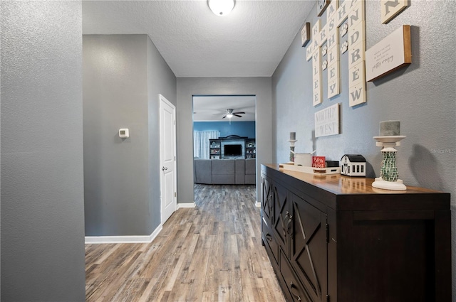 4662 Osprey Way, Winter Haven, FL 33881 - hall featuring light wood-type flooring, a textured ceiling, and a textured wall