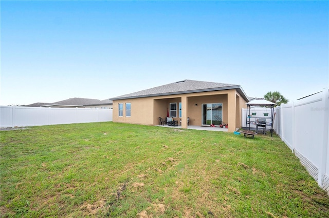 4662 Osprey Way, Winter Haven, FL 33881 - back of property featuring stucco siding, a fenced backyard, a gazebo, and a patio area