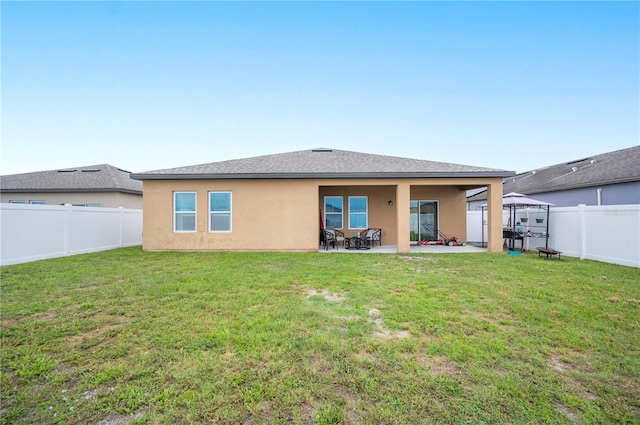 4662 Osprey Way, Winter Haven, FL 33881 - rear view of property with stucco siding, a fenced backyard, a patio, and a shingled roof