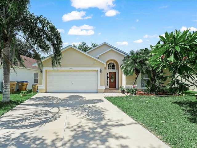 2538 Crown Ridge Cir, Kissimmee, FL 34744 - view of front of property with stucco siding, concrete driveway, a garage, and a front yard