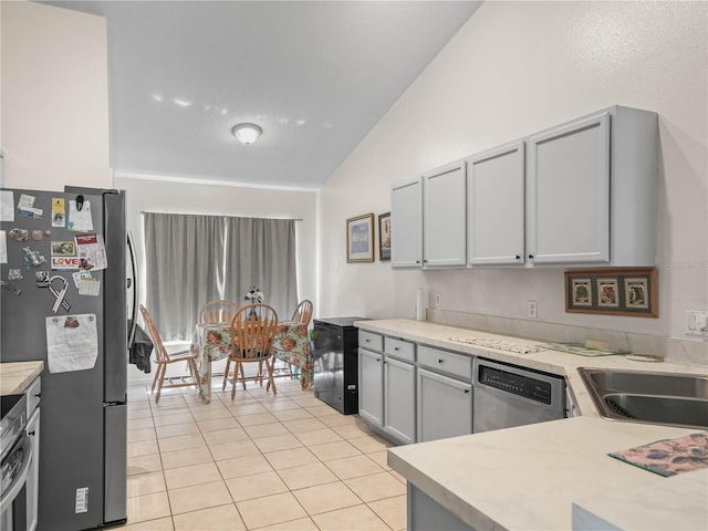 2538 Crown Ridge Cir, Kissimmee, FL 34744 - kitchen with vaulted ceiling, stainless steel appliances, light countertops, and light tile patterned flooring