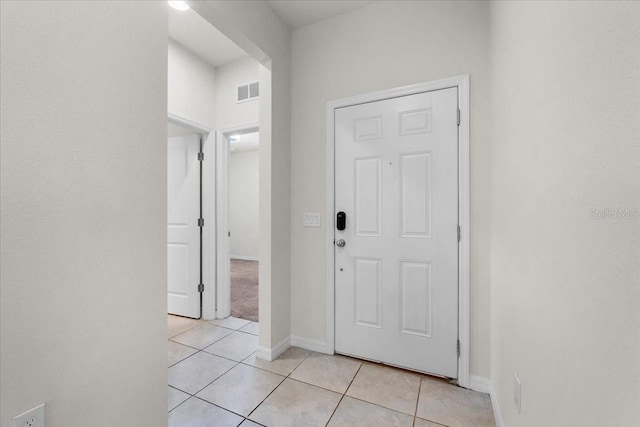 8720 Micmac Ct, Polk City, FL 33868 - foyer featuring light tile patterned flooring and baseboards