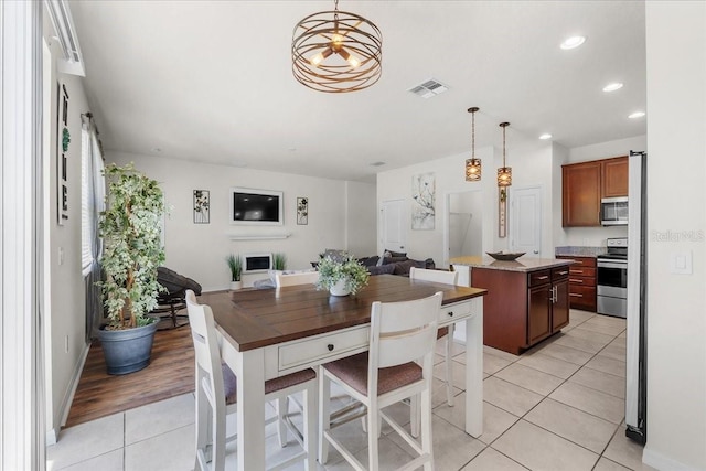8720 Micmac Ct, Polk City, FL 33868 - dining space featuring light tile patterned floors and recessed lighting