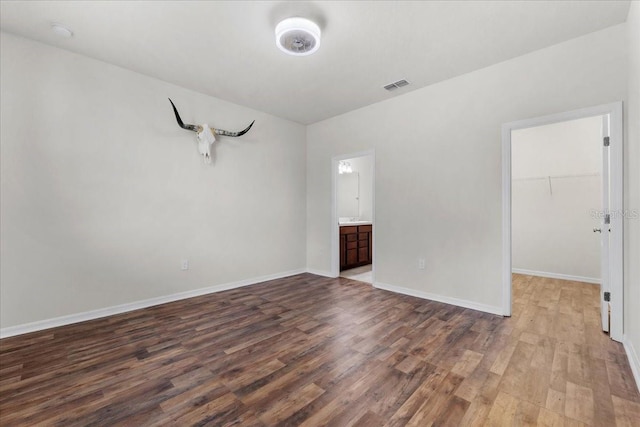 8720 Micmac Ct, Polk City, FL 33868 - spare room featuring wood finished floors and a smoke detector
