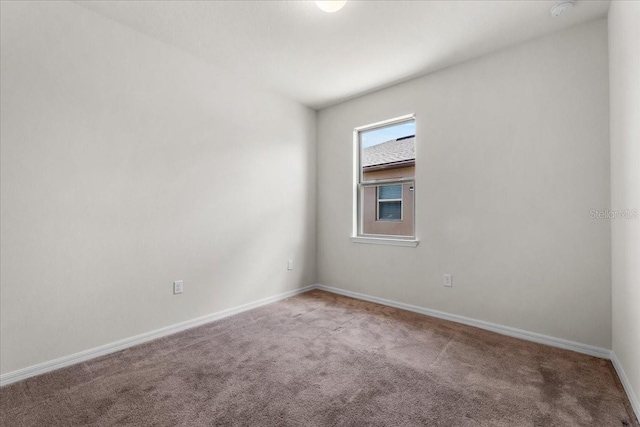 8720 Micmac Ct, Polk City, FL 33868 - carpeted spare room featuring a smoke detector and baseboards