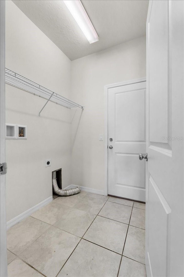 8720 Micmac Ct, Polk City, FL 33868 - laundry room with electric dryer hookup, light tile patterned flooring, and hookup for a washing machine