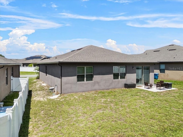 8720 Micmac Ct, Polk City, FL 33868 - rear view of house with a patio, a shingled roof, stucco siding, and a fenced backyard