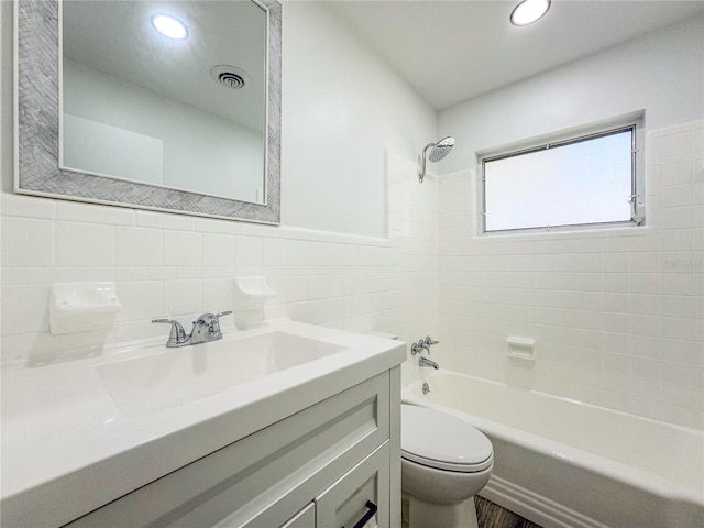 938 Glenwood Ave, Sebring, FL 33870 - full bathroom with tile walls, vanity, tub / shower combination, and recessed lighting