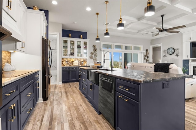 545 Pond Cypress Ct, Auburndale, FL 33823 - kitchen featuring black appliances, premium range hood, white cabinetry, ceiling fan, and light wood-style flooring